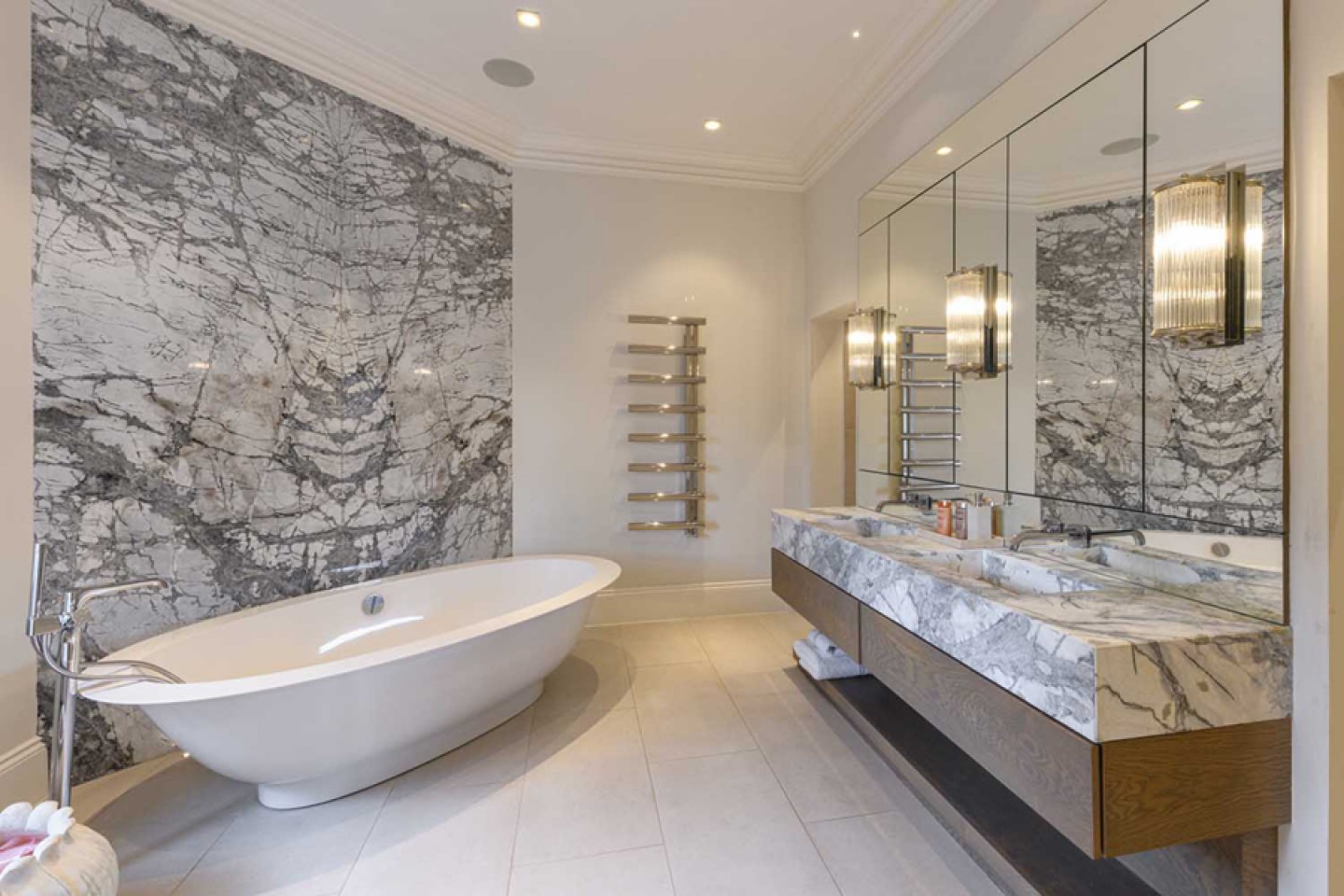 Luxurious bathroom with a freestanding bath, twin marble basins and a rainforest shower.